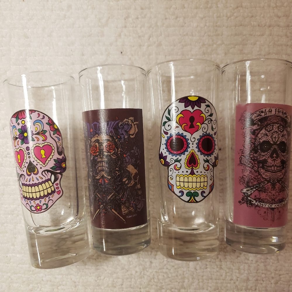 Set of 4 sugar skull shot glasses Each glass has a different design vtg 2009